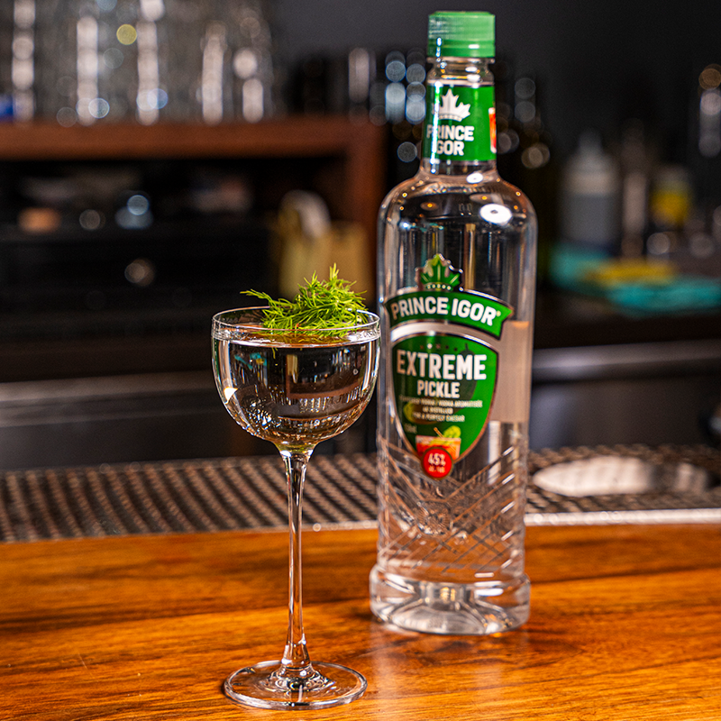 A smoked dill martini a bottle of Prince Igor Extreme Pickle Flavoured Vodka